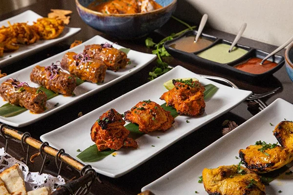 Grilled tandoori chicken kebabs served on platter